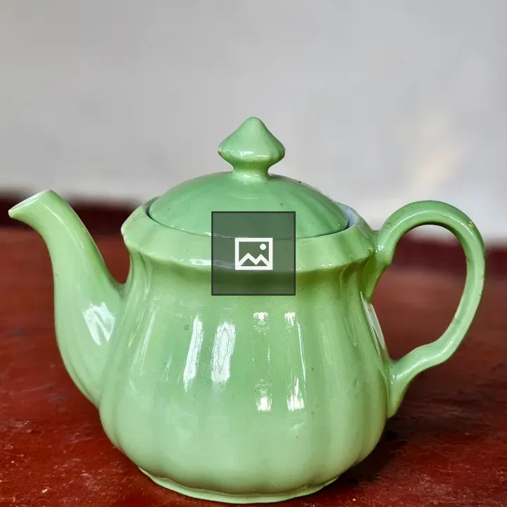 Glossy green teapot