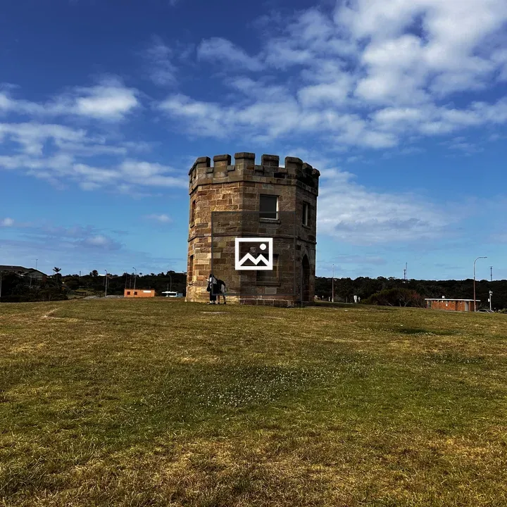 Stone tower on grassy hill