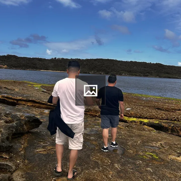 Two people on rocky shore