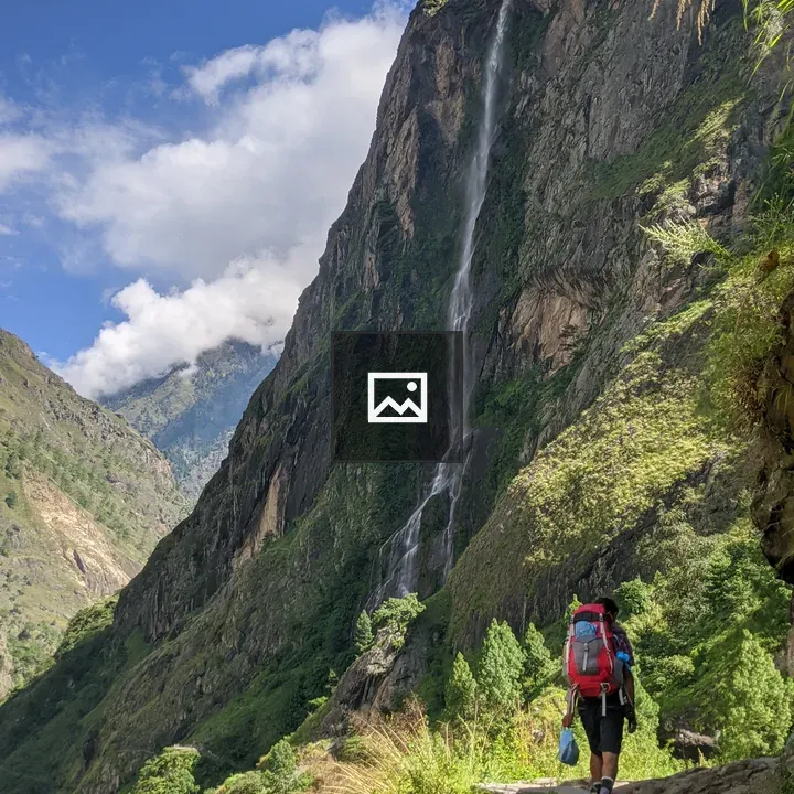 Hiker with Red Backpack on Stone Path