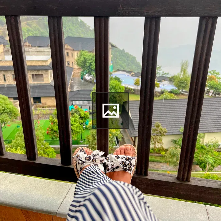 Feet in Floral Sandals on Balcony