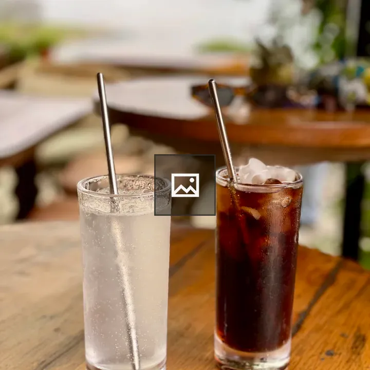Two iced drinks on wooden table