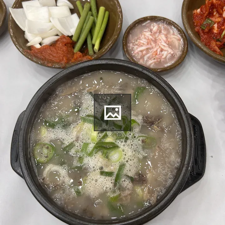 Black stone bowl with steaming soup