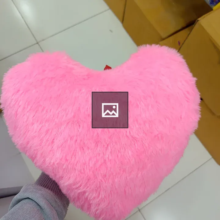 Person with pink heart pillow