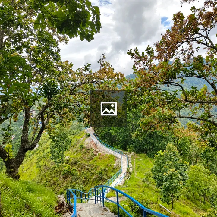 Winding stone staircase with blue railings