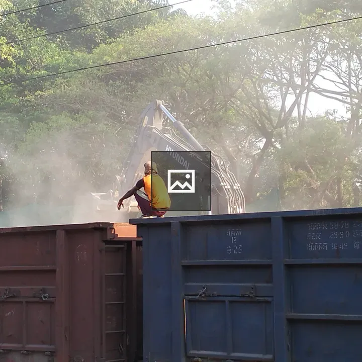 Laborer on Rail Rack near Excavator