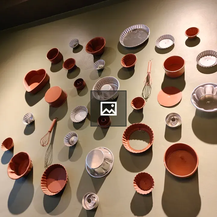 Pans and Tools on Green Wall