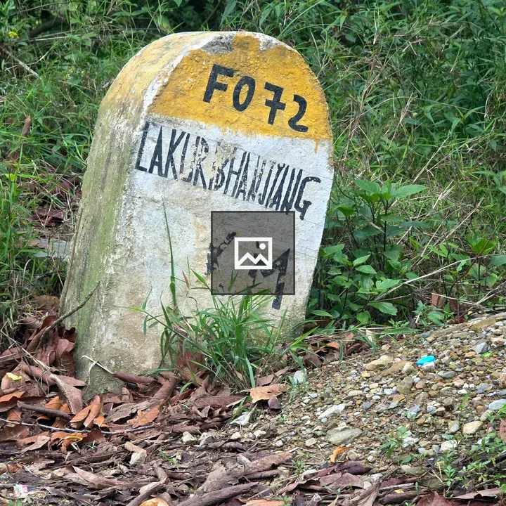 Weathered milestone with markings