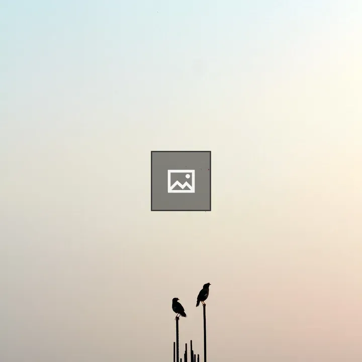 Two birds on tall metal rods