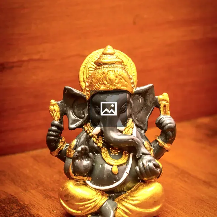 Ganesha statue on wooden surface