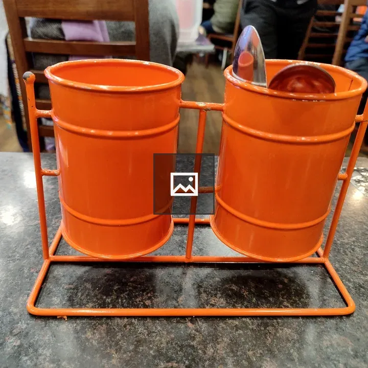 Two orange containers on stand