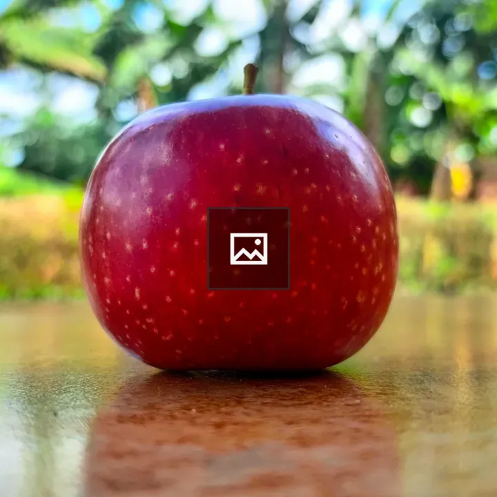 Red Apple on Reflective Surface