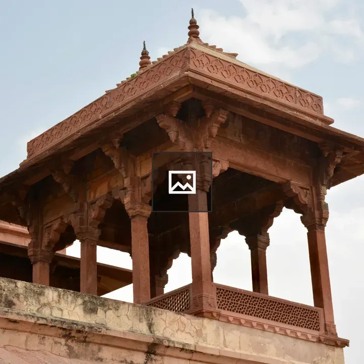 Red sandstone chhatri against sky
