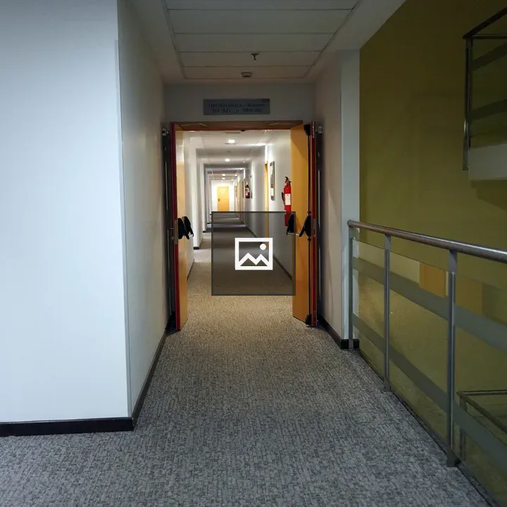 Long Hallway with Doors and Staircase