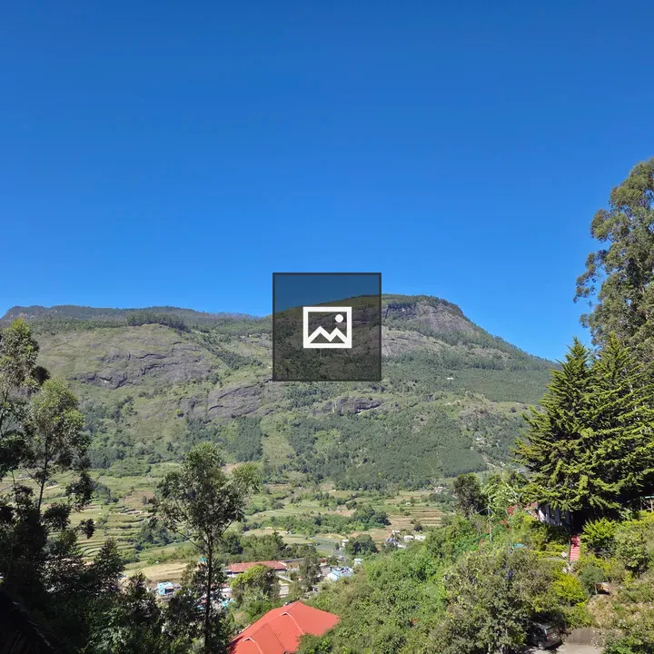 Terraced mountains beneath blue sky