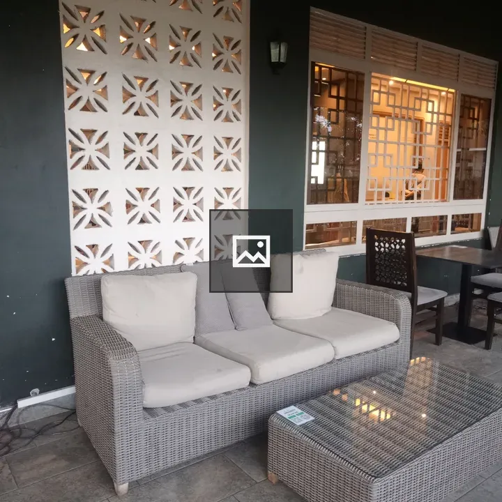 Cozy seating area with gray wicker sofa