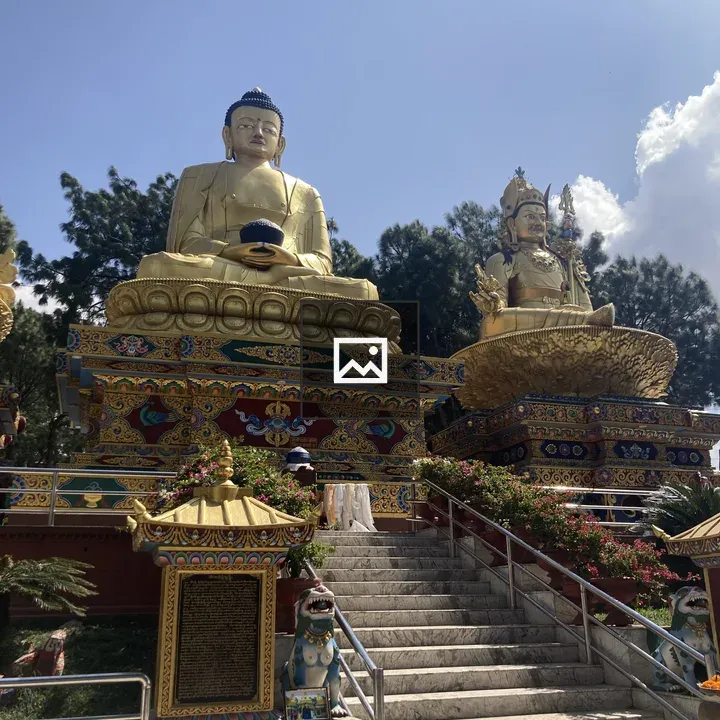 Buddha statue and ornate deity seated