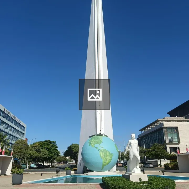 Tall obelisk monument with globe sculpture