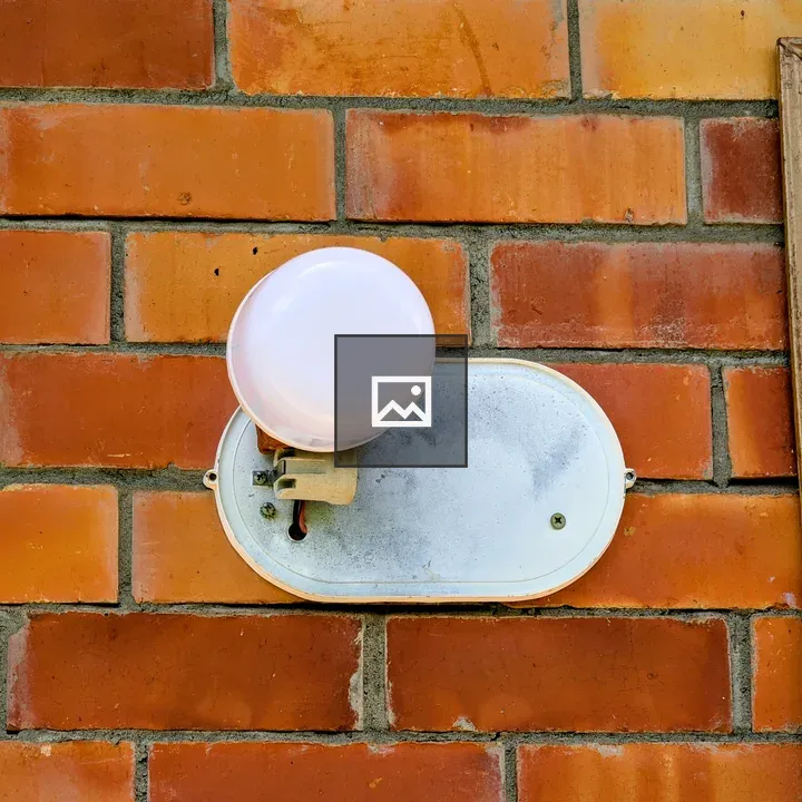 White light fixture on red brick wall