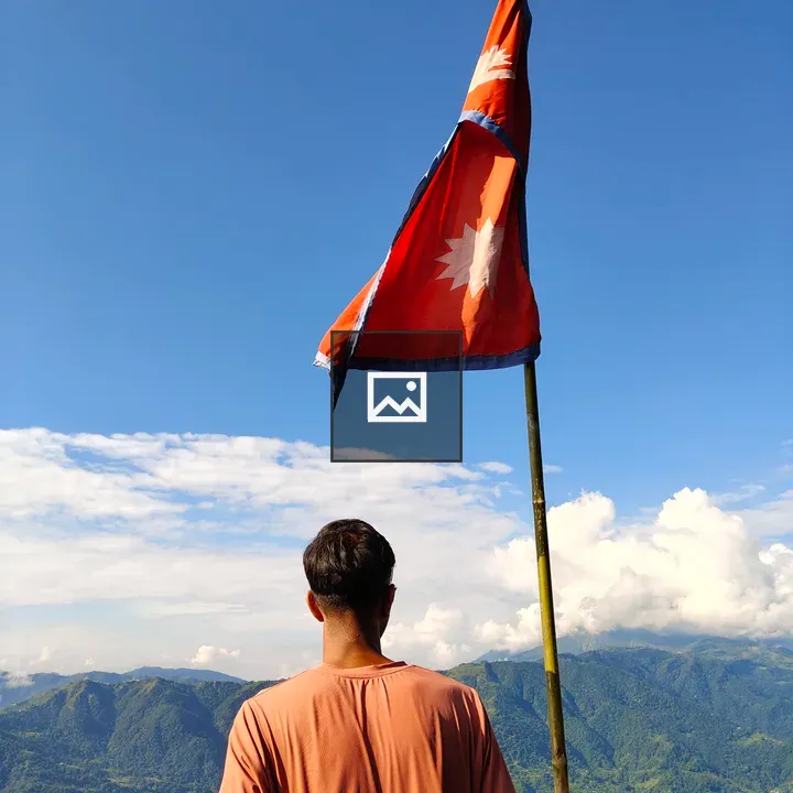 Person with Nepal flag in mountains