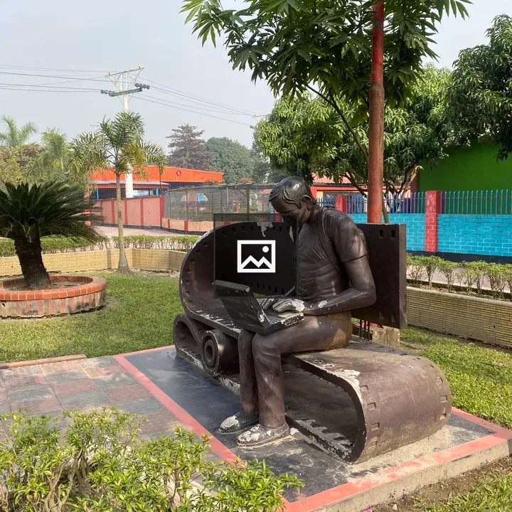 Sculpture on a bench with laptop
