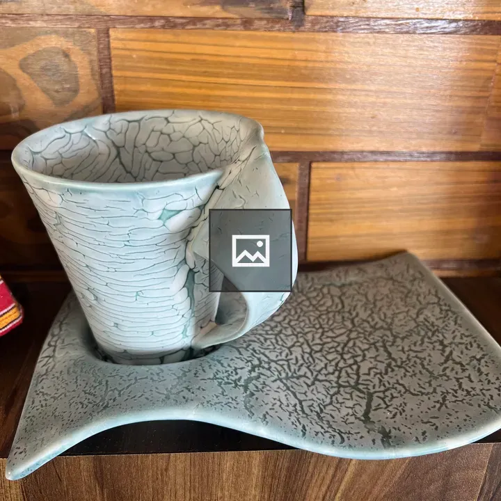 Light blue ceramic mug on saucer