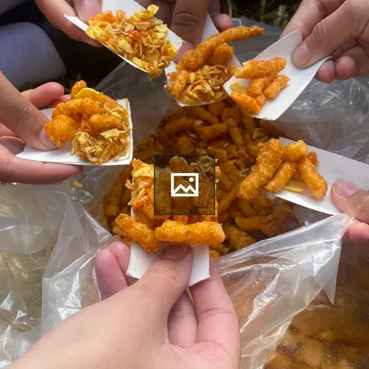 Hands holding snack trays