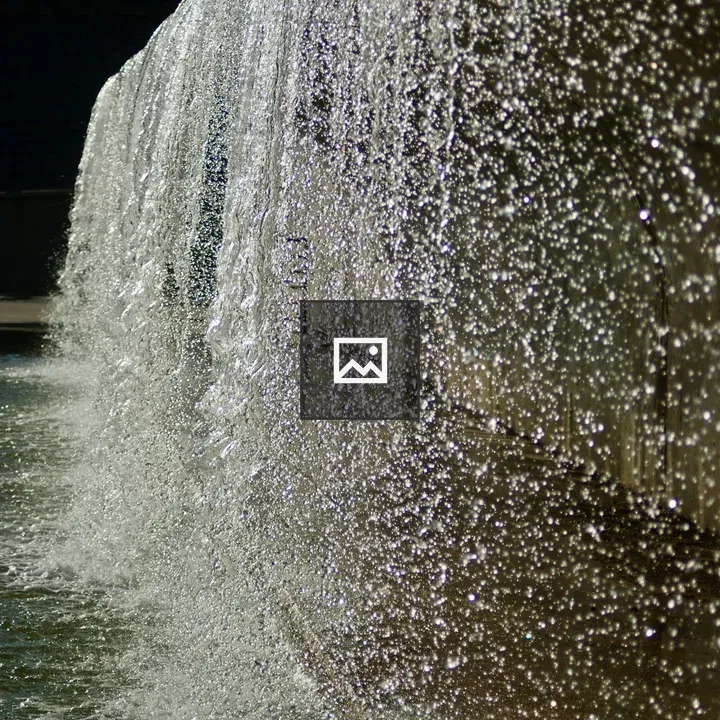 Water cascading on textured wall