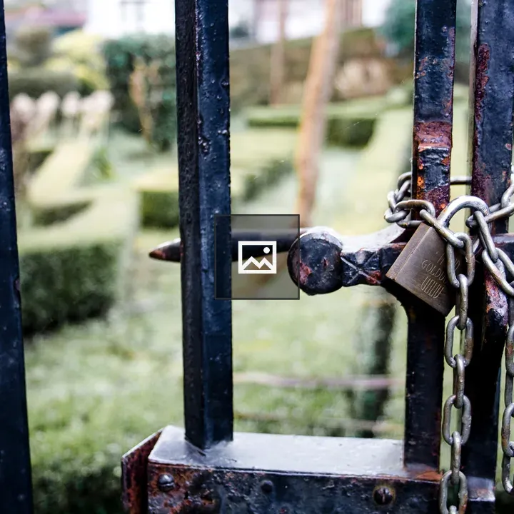 Rusty fence with chains and padlock