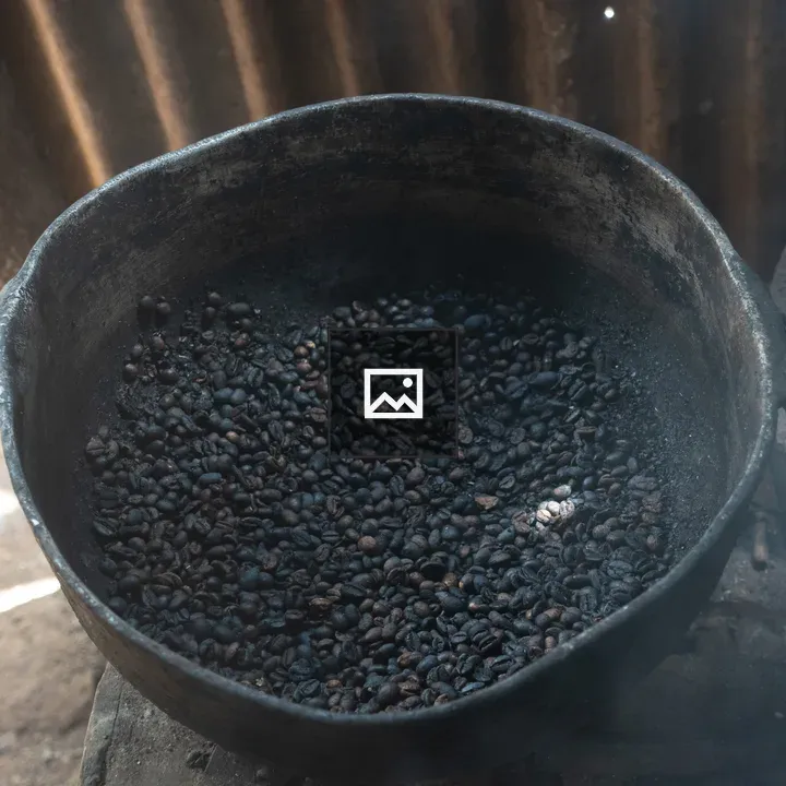Metal pot with roasted coffee beans