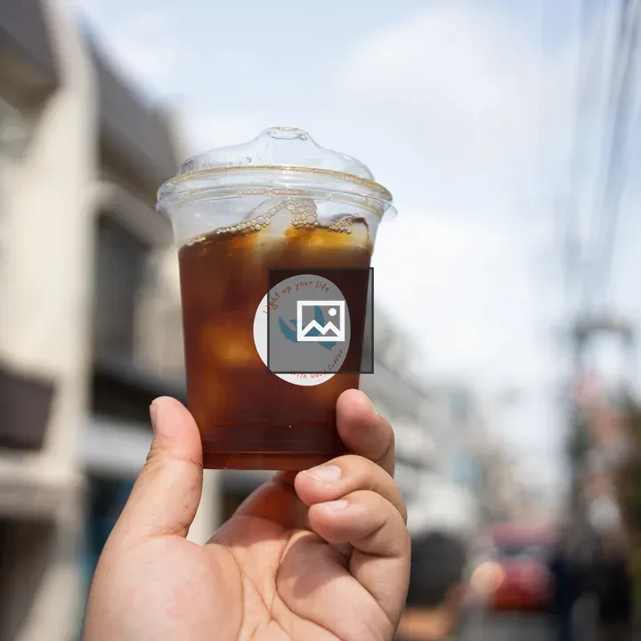Ice coffee in hand cup