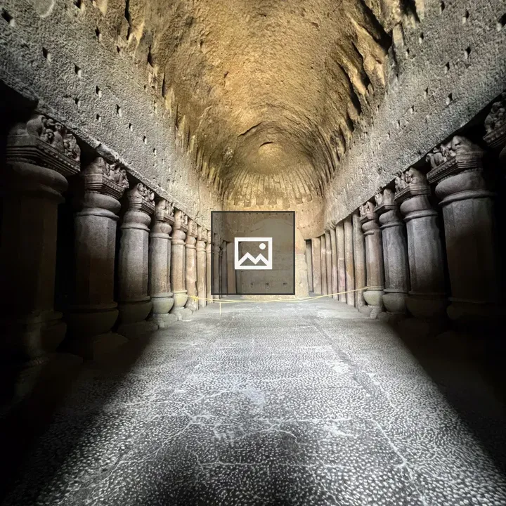 Ancient rock-cut cave hall with pillars