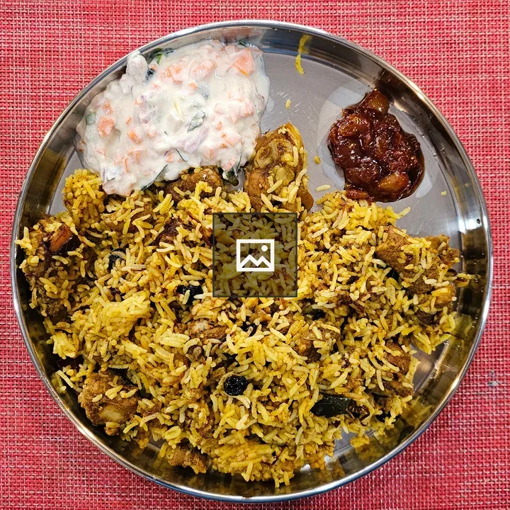 Chicken biryani plate with dates pickles