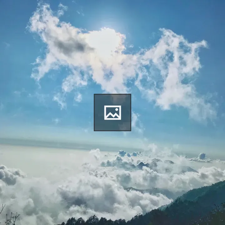 Sun behind clouds over blue sky
