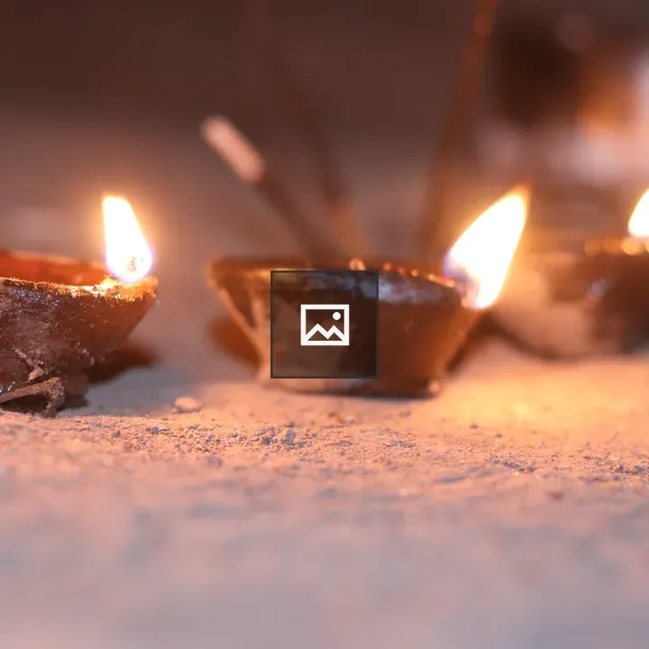 Three clay oil lamps on sand