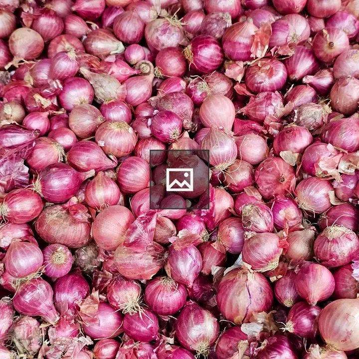 Pile of Red Onions at Market