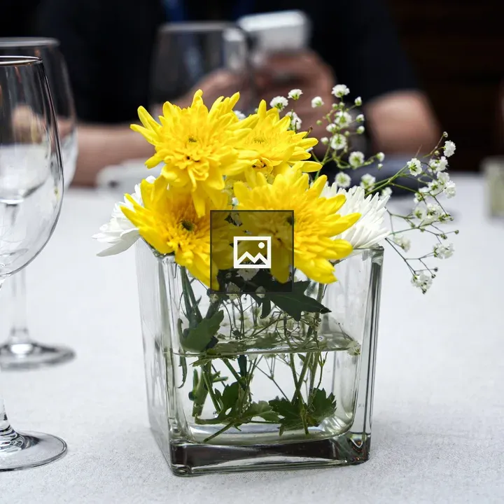 Glass vase with flowers on table
