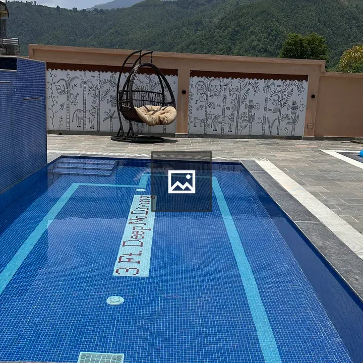 Swimming pool with blue tiled water