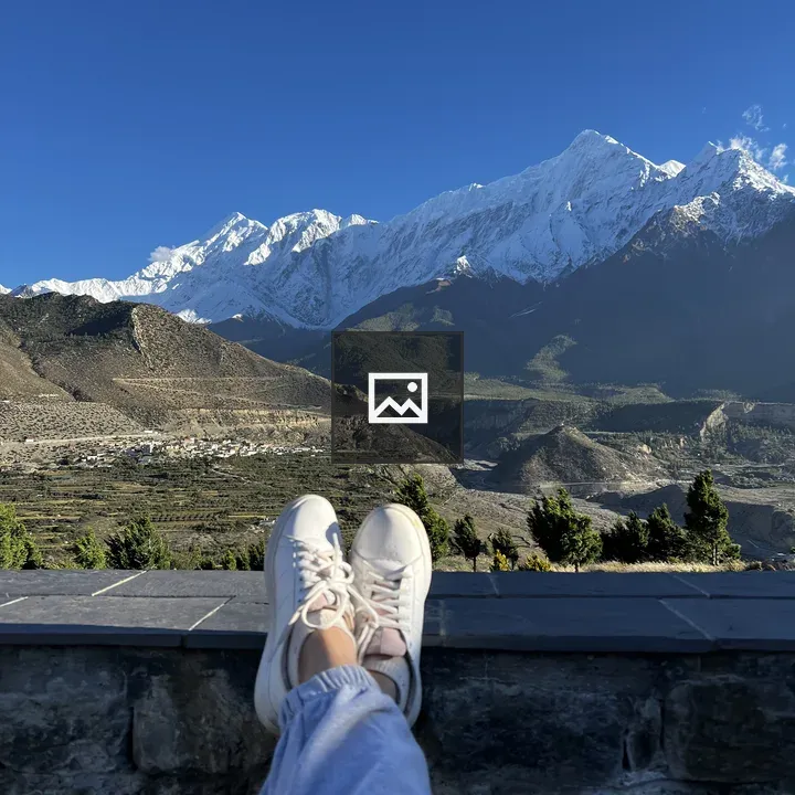 Feet on wall with mountain view