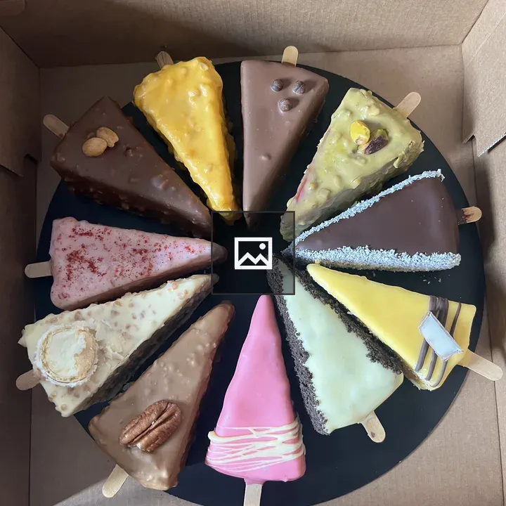 Colorful triangular cake slices on sticks
