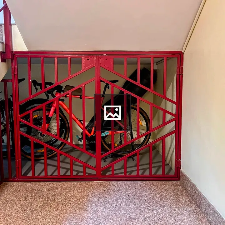 Red metal gate with bicycles