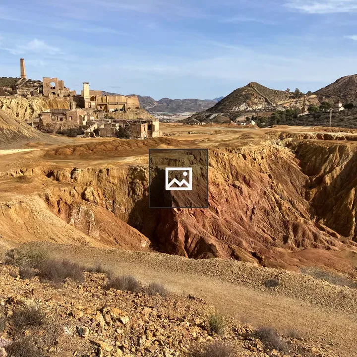 Barren erosion landscape with distant chimneys