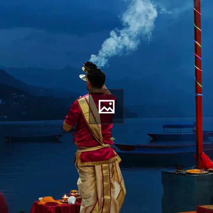 Person in Traditional Attire by Lake