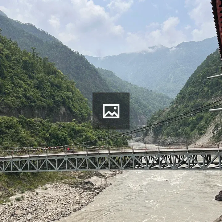 Suspension bridge over winding river