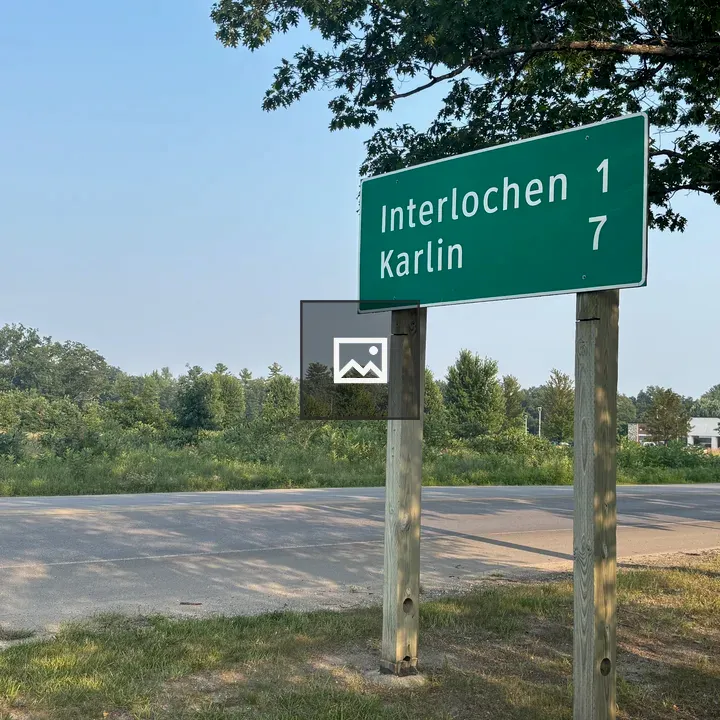 Green road sign with city distances