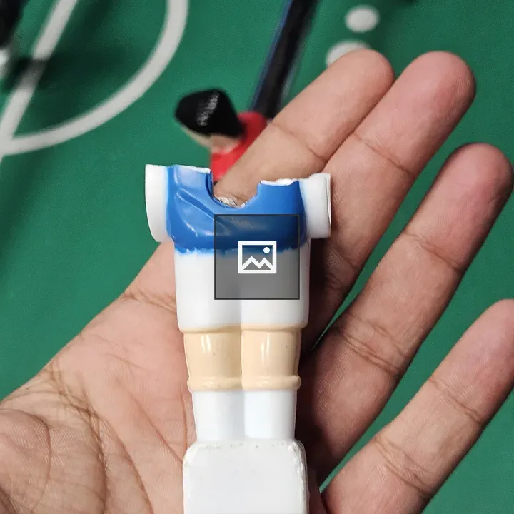 Broken Foosball Figurine Held in Hand