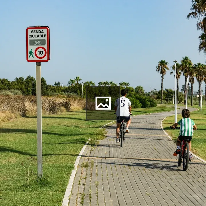 Two Children on Bicycles in Park