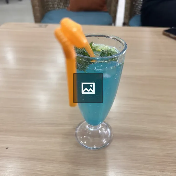 Blue beverage in glass with mint
