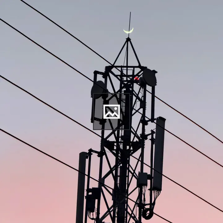 Radio tower against twilight sky