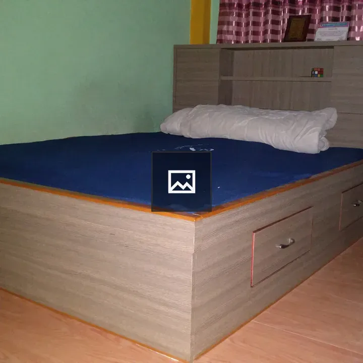 Bed with blue cover in bedroom